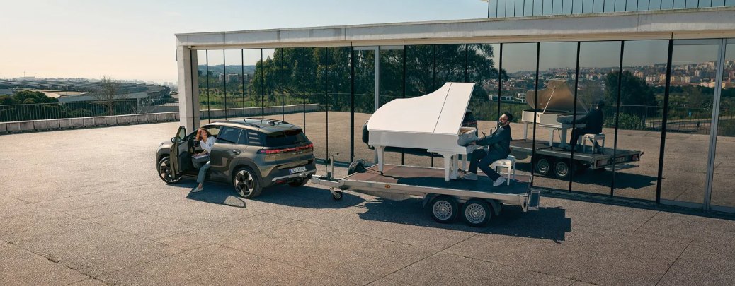 Volkswagen ID. Cross tractând o platformă pe care se află un pian alb